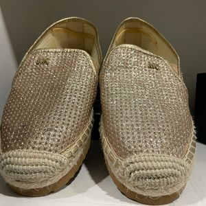 Michael Kors gold espadrille flats.